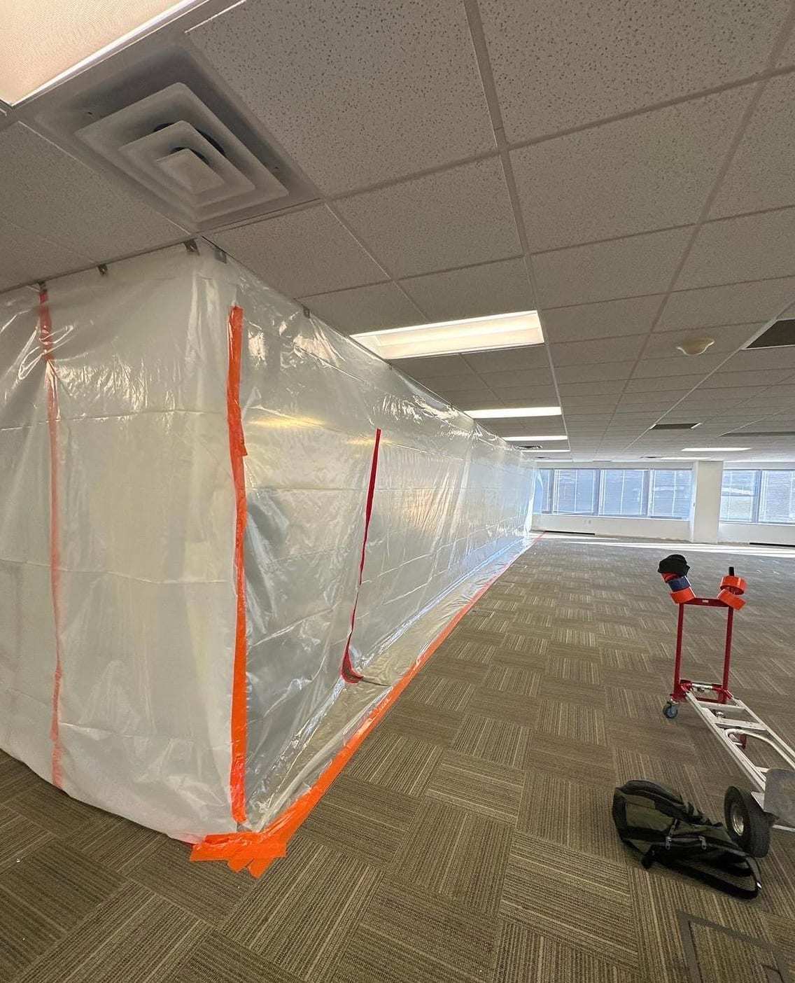 Office floor divided by a long plastic containment wall